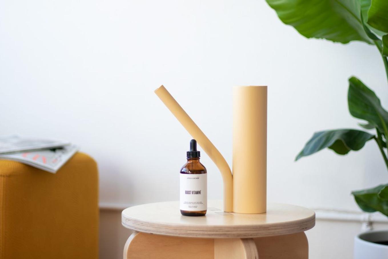 Plant food and watering can on wood pedestal